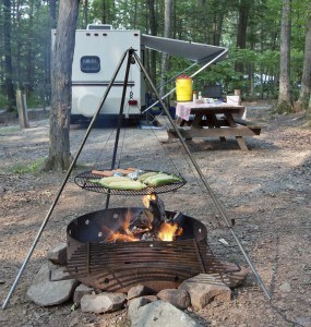 food being cooked over open fire at camp ground